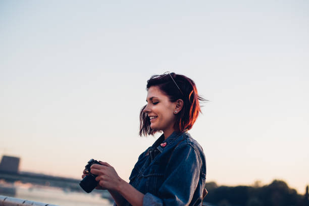 istock Lady photographer by the river 870951786