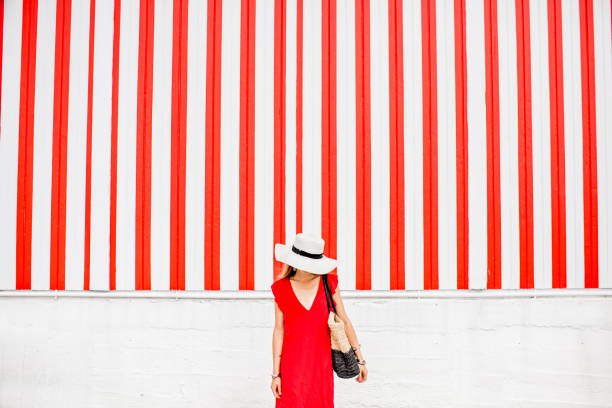 istock Woman on the red striped wall background 870952142