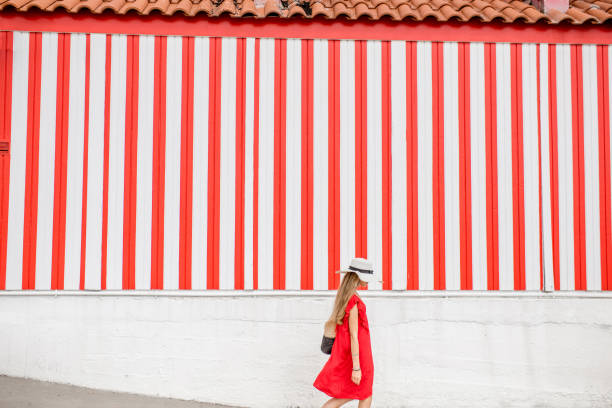 istock Woman on the red striped wall background 870952192