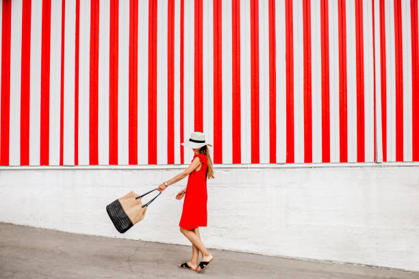 istock Woman on the red striped wall background 870952216