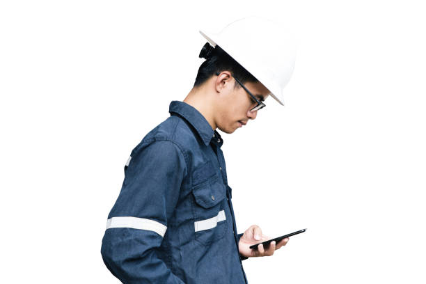 istock Asian man,Engineer or Technician in white helmet, glasses and blue working shirt suit using smart phone, isolated on white, mechanic and Oil and Gas industrial concept with clipping path. 870968460