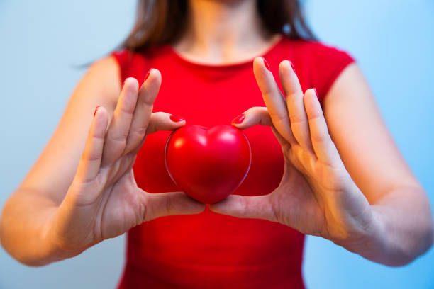 istock Heart in woman's hands with red manicure 870968662