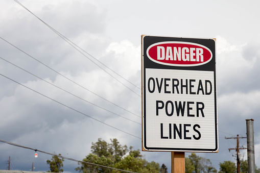 Danger overhead power lines sign