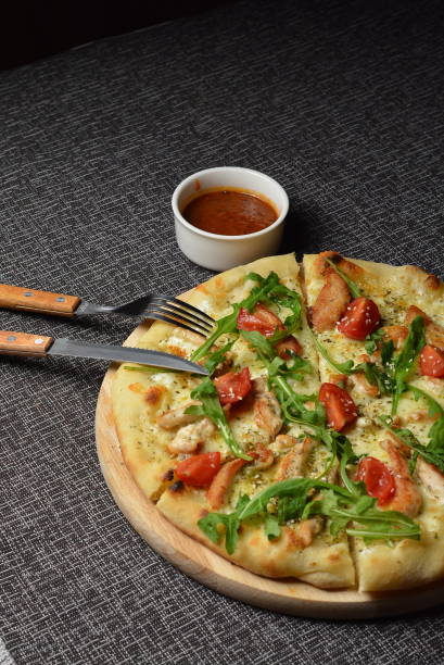 istock Rustic pizza with salami, mozzarella, olives and basil 870975468