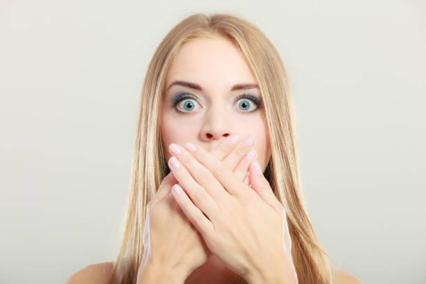 istock Amazed woman covering her mouth with hands 870979172