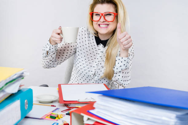 istock Happy woman at office drinking hot coffee 870981860