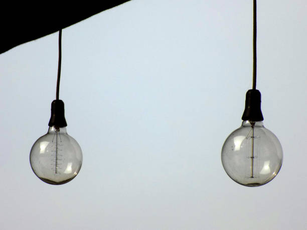 istock Vintage lighting bulbs hanging on the cable 870989592