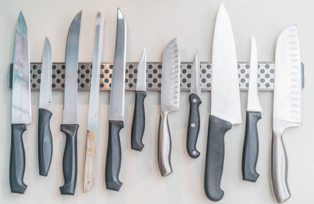 istock Domestic kitchen knives arranged on magnetic knife rack 870994294