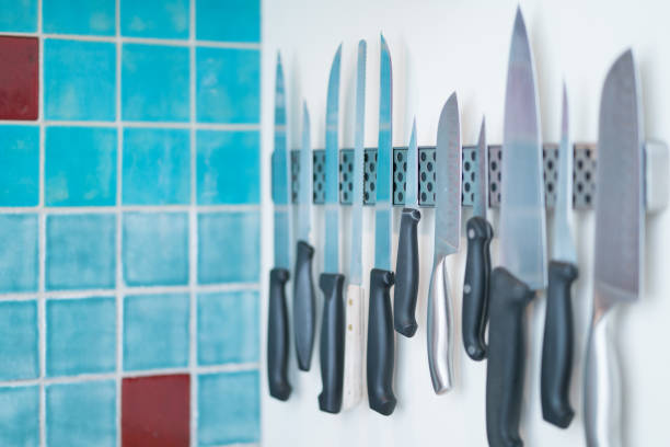 istock Domestic kitchen knives arranged on magnetic knife rack 870994598