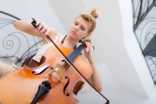 istock Female musician playing cello 870995924