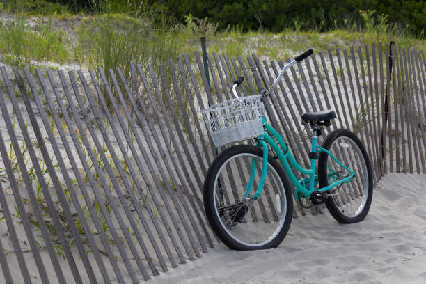 istock Vintage turquoise bicycle on the beach 870999190