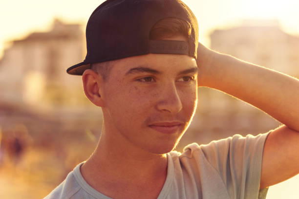 istock happy hipster boy with cap in sunset light 871005338