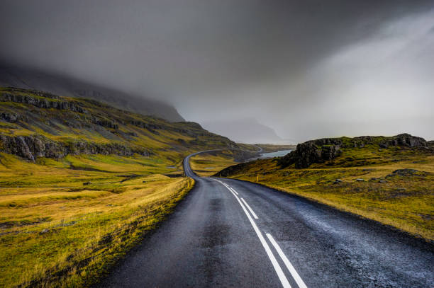 istock Empty Street with Icelandic Landscape during with misty mountain 871005870