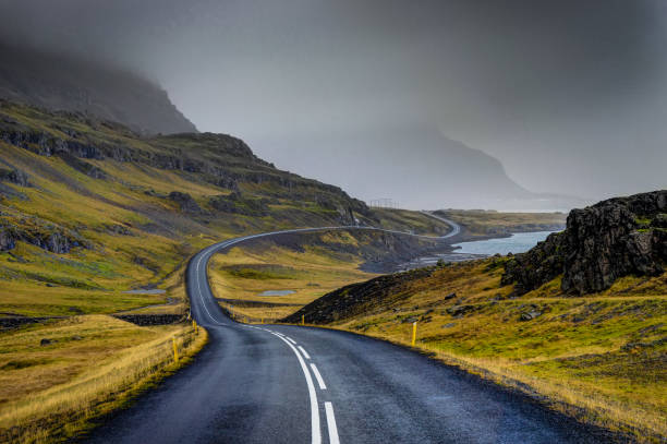 istock Empty Street with Icelandic Landscape during with misty mountain 871006008