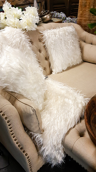 Sofa with cushions and a fur throw in a living room