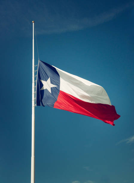 istock State flag of Texas flying at half-mast 871010882
