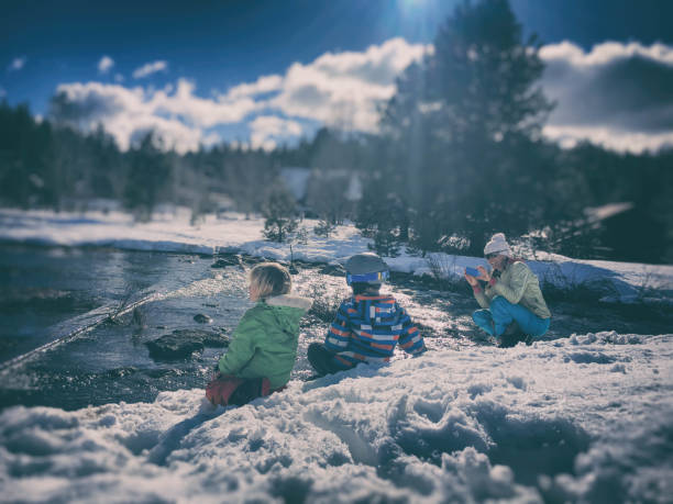 Children playing in a snowy wilderness after a big storm in California in winter