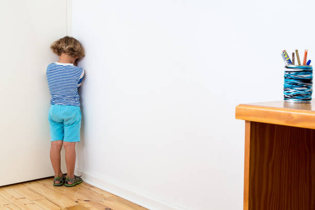 Bullied child Child in naughty corner, being bullied, having time out or having a tantrum. child behaving badly stock pictures, royalty-free photos & images