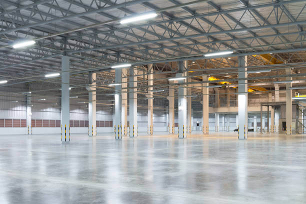 factory floor background Empty factory building or warehouse building with concrete floor for industry background. industrial building stock pictures, royalty-free photos & images
