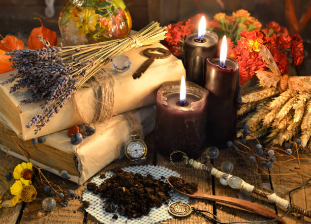 istock Black candles, old books, lavender flowers and magic objects 871028404