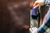 Female Hand Using Keyless Entry Card Into Hotel Room Door Lock