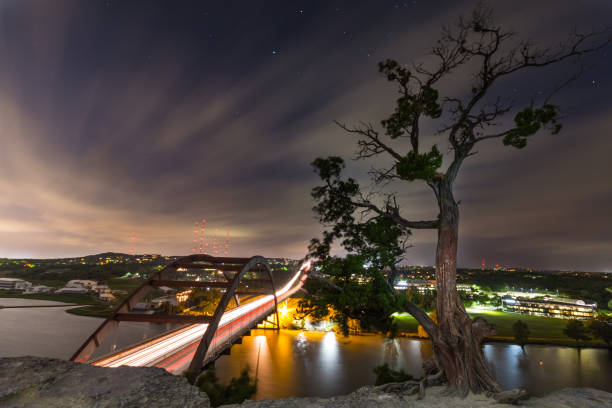 istock Pennybacker 360 Bridge Wide Angle Long Exposure At Night With Streaming Clouds & Colorado River 871033726