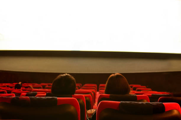 happy couple watching movies at the movie theater - process noise effects - audience surprise movie theater shock imagens e fotografias de stock