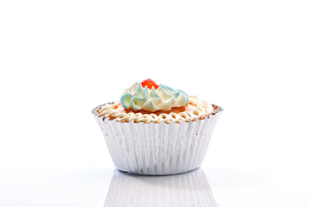 istock An isolated cupcake with sprinkles on a white background 871050104