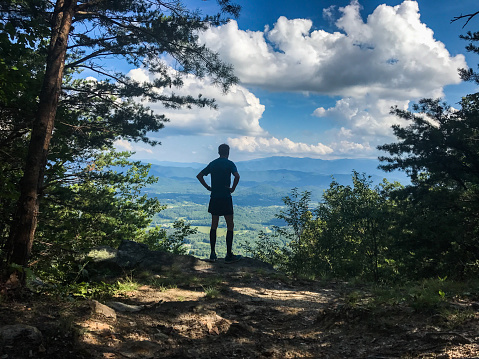 a man stands on an overlook near great smoky mountains national park along the appalachian trail.