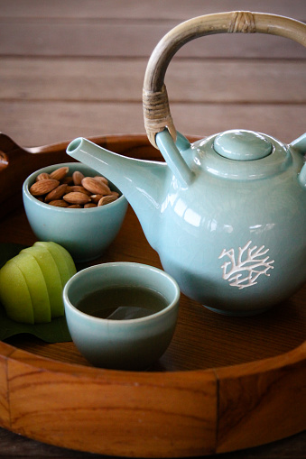 Tea Pot with Ginger tea and Refreshments on tray in Asian Spa
