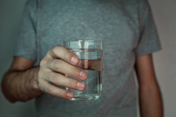 istock Man hand glass of water 871067944