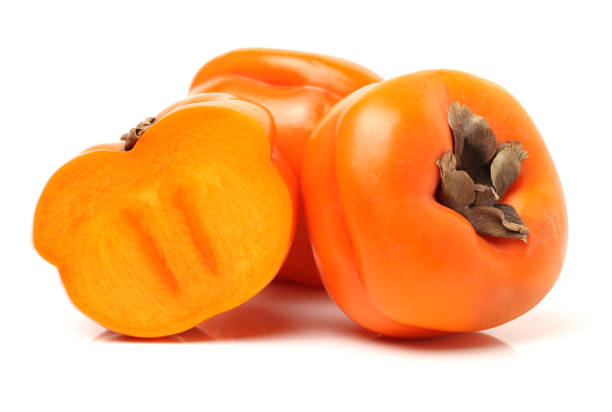 istock Whole and half cut ripe persimmon on white background 871070346