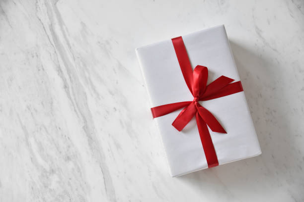 istock Top view of white gift boxes with red ribbon. 871071264