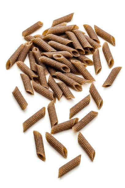 Macro color photo of uncooked whole grain rotini pasta intended to be used as a food backgroundHorizontal composition