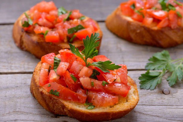 istock Bruschetta with tomatoes on wooden table. Closeup 871078054