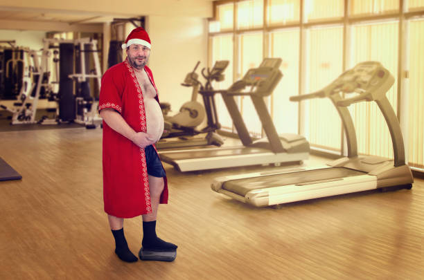 Santa knows how easy to gain weight during Christmas festival stock photo