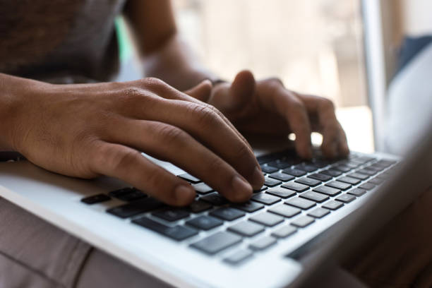 istock Close up of unrecognizable man typing on laptop. 871081784