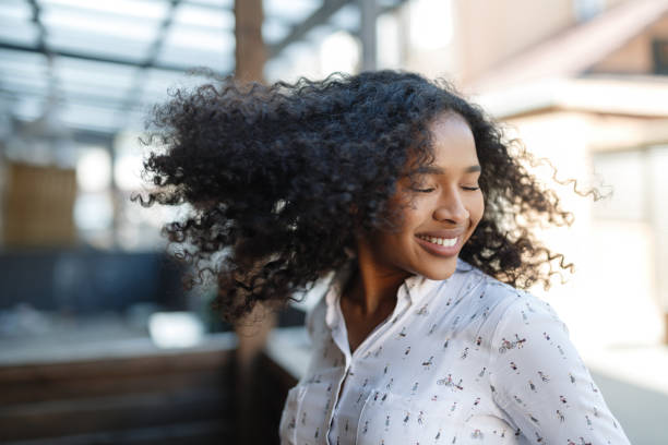 istock Young woman enjoying a day, posing outdoors with eyes closed 871082458