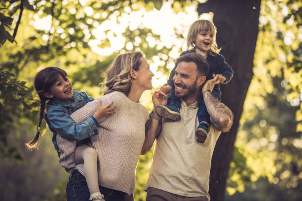 istock Young playful family having fun during spring day in nature. 871086348