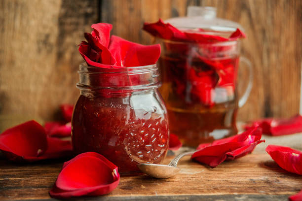 istock Jar of rose petal jam on a wooden table 871086868