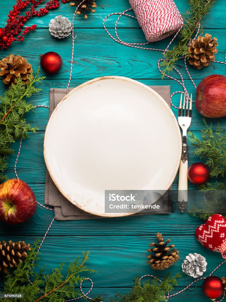 Christmas background with dish and cutlery Christmas dark green background with empty dish and cutlery. Festive holiday dinner concept Christmas Stock Photo