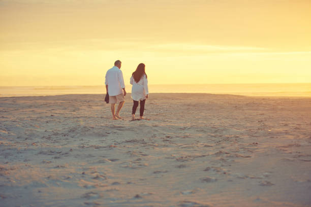 istock Enjoying a long walk on the beach 871090762