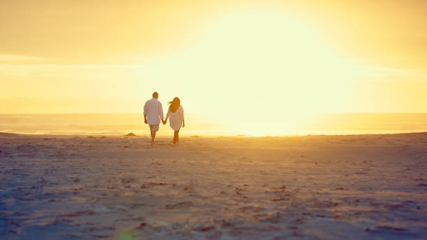 istock Walking hand in hand on the beach 871090774
