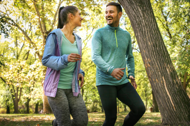 istock Running together two young people trough forest. 871091126