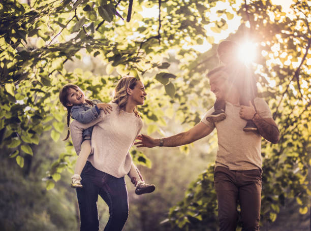 istock Joyful family taking a walk in nature and having fun together. 871091816