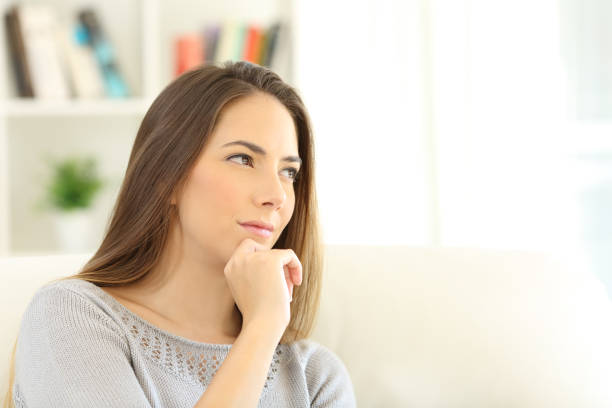 istock Pensive woman wondering at home 871094500