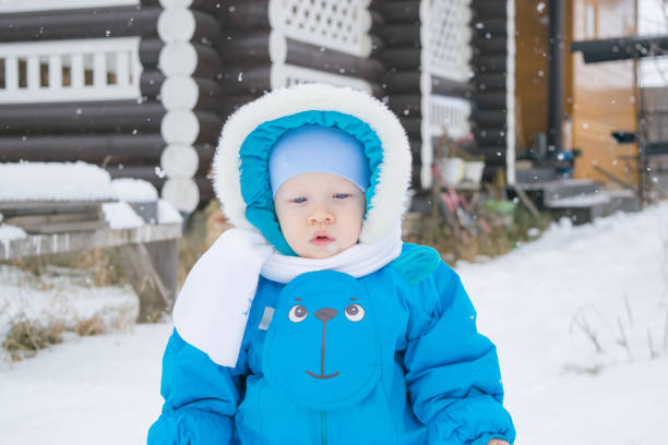 istock Baby boy walking at a snow yard 871098560