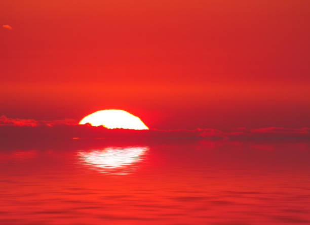 istock Nature sunset background: sun, clouds and the sea surface with waves. 871105144