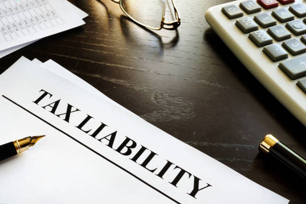 istock Papers with title tax liability on a desk. 871105358