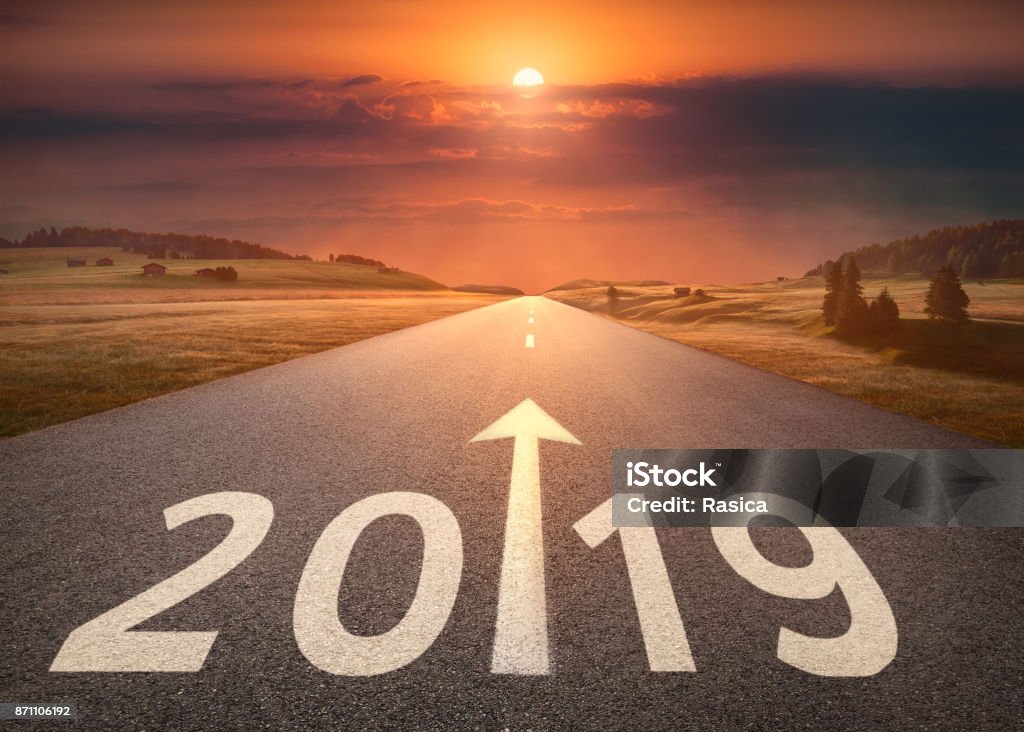 Beautiful empty highway to upcoming 2019 at sunset Driving on idyllic open road against the setting sun forward to new year 2019. Concept for success and future. 2019 Stock Photo